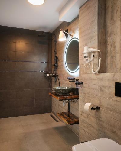 a bathroom with a sink and a shower at Piata Unirii Central Apartments in Iaşi