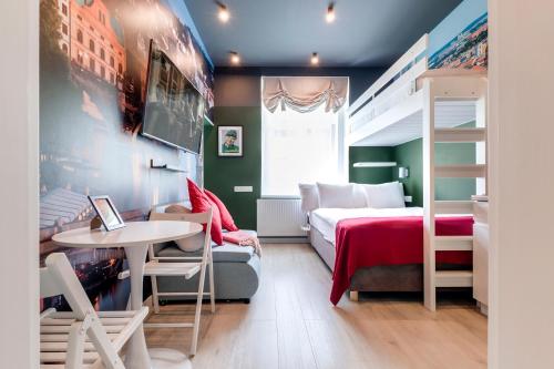 a bedroom with a bed and a desk and a table at Revelton Studios Prague in Prague