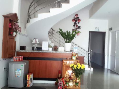 a room with a staircase and a table with flowers at Motel Thanh Long in Da Nang