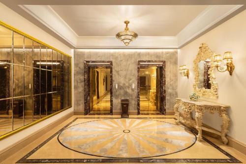 a hallway with a large room with a circular rug on the floor at The Hillock Ahmedabad in Ahmedabad