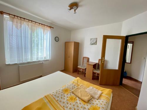 Schlafzimmer mit einem Bett, einem Tisch und einem Spiegel in der Unterkunft Vila Heda in Franzensbad