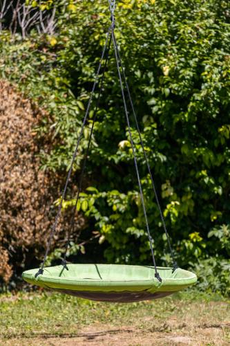 a green boat hanging from a rope swing at Le Gite du Chevreuil, 200 Mètres de BEAUVAL in Saint-Aignan