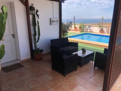 a living room with a view of a swimming pool at Vista al Mar Ylenia in Almería