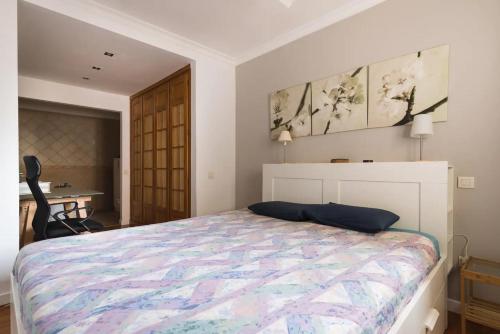 a bedroom with a bed and a table and a chair at Casa Lucy in Las Palmas de Gran Canaria