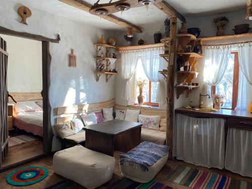 a bedroom with a bed and a table in a room at Екосадиба Лісова Казка in Dmitrenki