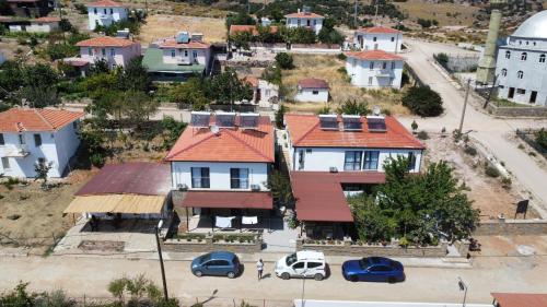 an aerial view of a town with cars parked in a parking lot at Imbrossa Hotel in Gokceada Town