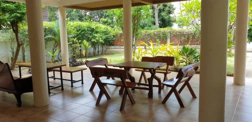 eine Veranda mit einem Tisch und Stühlen auf einer Terrasse in der Unterkunft บ้านรับพร in Nakhon Phanom
