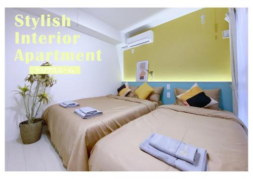 two beds sitting next to each other in a room at nestay apartment tokyo ginza in Tokyo