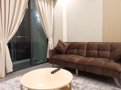 a living room with a couch and a table at The Ooak Suites and Residence@ Kiara 163 in Kuala Lumpur