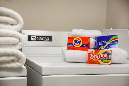 a pile of towels sitting on top of a stack of towels at Super 8 by Wyndham Big Timber in Big Timber