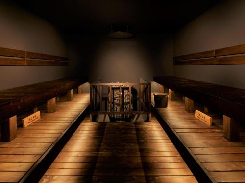 an empty room with rows of wooden benches at hotel androoms Sapporo Susukino in Sapporo