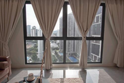 a room with large windows with a view of a city at The Ooak Suites and Residence@ Kiara 163 in Kuala Lumpur