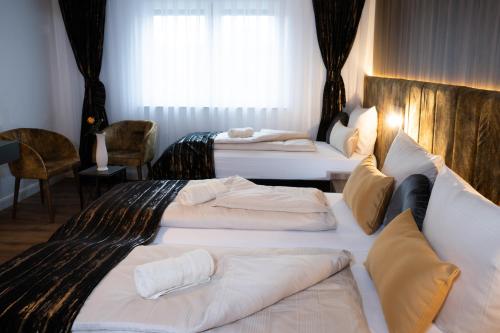 a hotel room with two beds and a window at Grand Hotel in Soltau