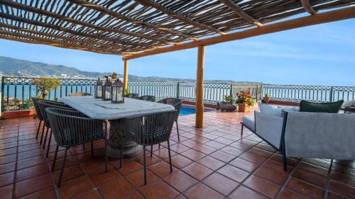 a patio with a table and chairs on a balcony at Fiesta Americana Puerto Vallarta All Inclusive & Spa in Puerto Vallarta