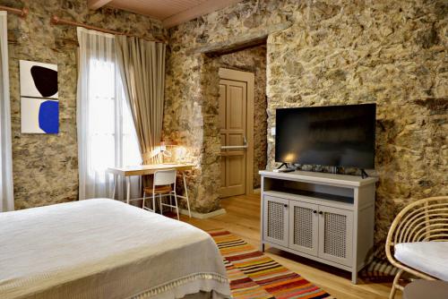 a bedroom with a bed and a flat screen tv at Bono Hotel Old Town in Marmaris