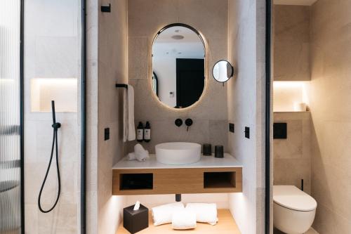 a bathroom with a sink and a mirror at Boutique Hotel Petit Montisión in Palma de Mallorca