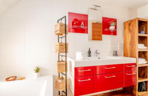 a bathroom with a red cabinet and a sink at Superbe Loft, Chalon sur Saône in Chalon-sur-Saône