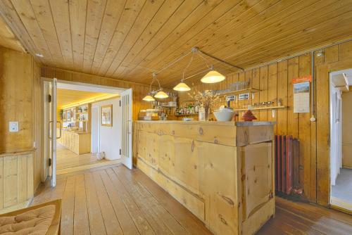 a kitchen with wooden walls and a counter in a room at Chalet Speciale - Celerina in Celerina