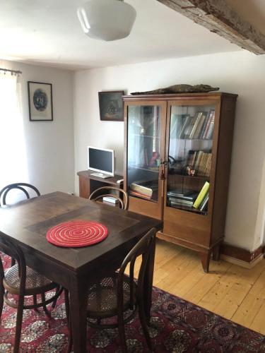 sala de estar con mesa de madera y armario en Les Rosiers en Eschbourg
