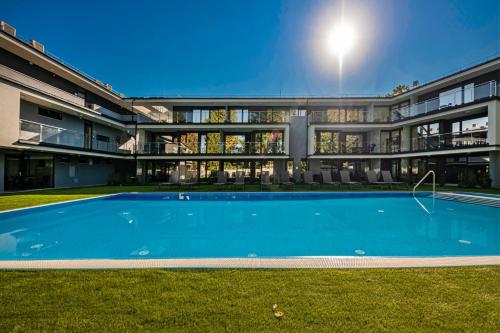 a large house with a large swimming pool in front of it at H55 in Balatonlelle