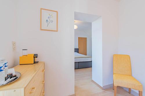 a room with a desk and a chair and a bed at Hôtel Le Petit Poète in Echternach