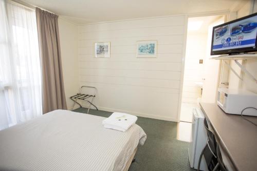 a hospital room with a bed and a flat screen tv at Corio Bay Motel in Corio