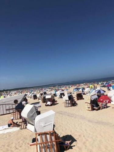 a group of people sitting on the beach at Swinoujscie Poland Luxury Penthouse Sleeps 9 in Świnoujście