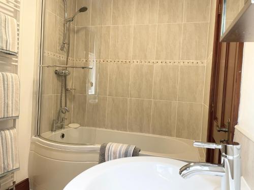 a bathroom with a shower and a tub and a sink at Milecastle Inn on Hadrian's Wall near Haltwhistle in Haltwhistle