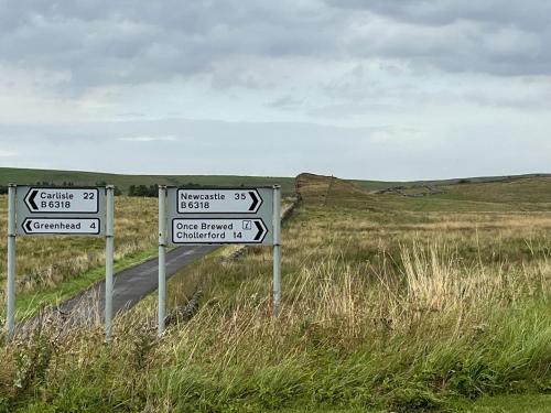 two street signs on the side of a road at Milecastle Inn on Hadrian's Wall near Haltwhistle in Haltwhistle