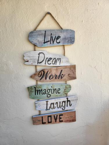 a group of wooden signs hanging on a wall at Casa de Almano - Torremolinos direct on beach in Torremolinos