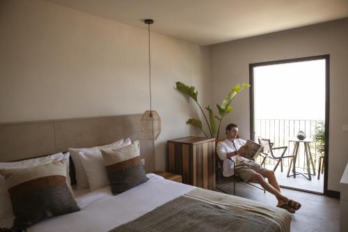Domes Aulus Elounda All-Inclusive Resort, Adults only, Curio by Hiltonにあるベッド