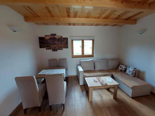 un soggiorno con divano e tavolo di Vule bungalovi a Žabljak
