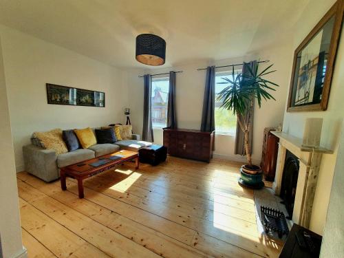 a living room with a couch and a fireplace at Sunny Apartment with a 10 minute walk to the Sea. in Kent