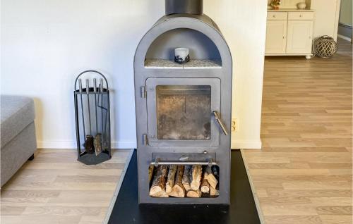 a wood fired oven in a living room at Nice Home In Ljungby With Wifi in Ljungby
