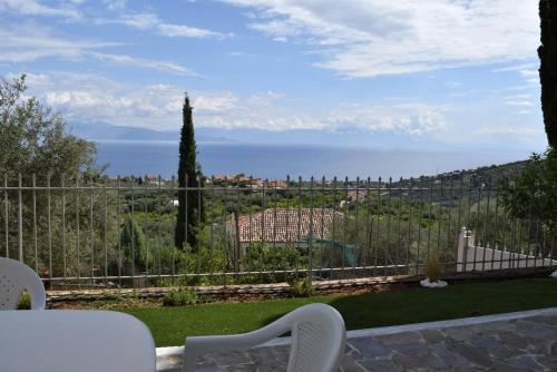 a view of the ocean from a house with a white chair at Corinthian Gulf View, Apartment 2 in Egira