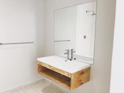 a bathroom with a sink and a mirror at Beach Garden Guesthouse with Self Catering in Swakopmund