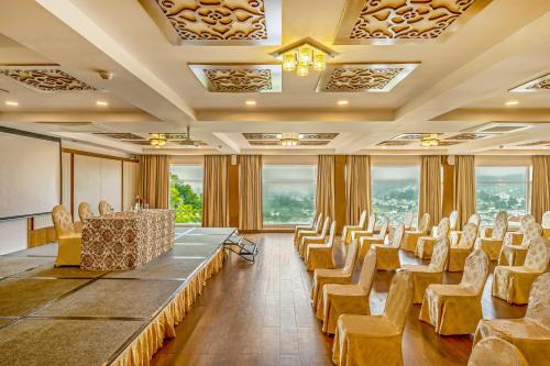 a conference room with chairs and a table and a podium at Sterling Ooty Elk Hill in Ooty