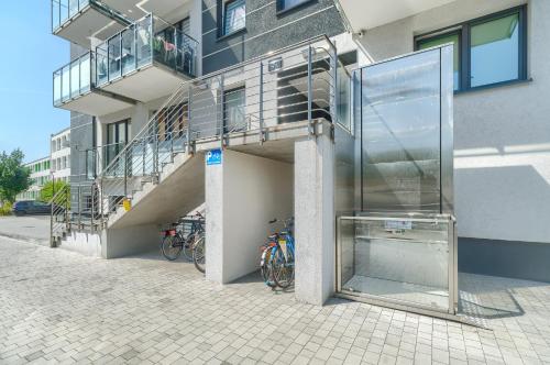 a glass entrance to a building with bikes parked outside at Silver Apartments in Świnoujście
