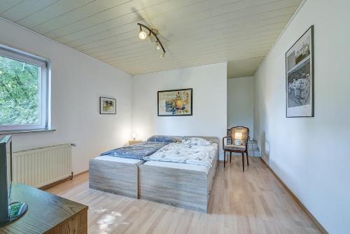 a bedroom with a bed and a table in it at Ferienwohnung in Remscheid-Ehringhausen in Remscheid