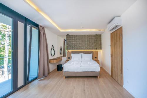 a bedroom with a bed and a large window at H55 in Balatonlelle