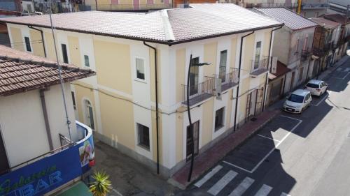 an overhead view of a yellow building on a street at Le Suite in Polistena