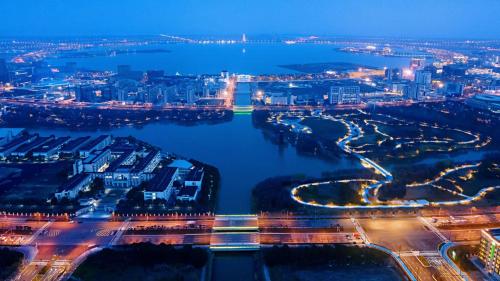 an aerial view of a river at night at Holiday Inn Shanghai Dishui Lake by IHG in Nanhui
