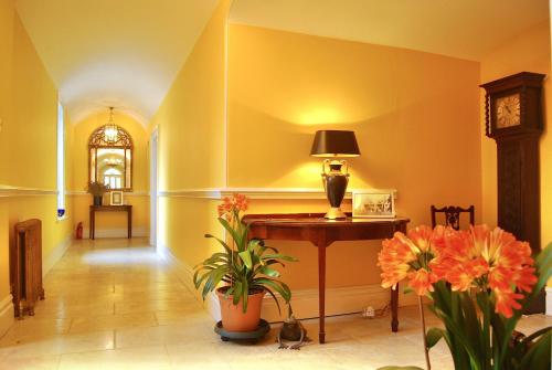 a hallway with a table and flowers in a room at Swafield Hall in Swafield