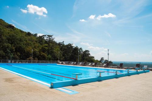 a large swimming pool on a sunny day at Rákóczi Hotel, Tábor és Rendezvényközpont in Sátoraljaújhely