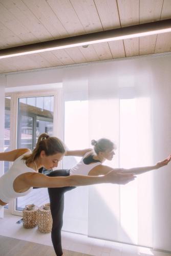 two women dancing in a room with a window at Stadthotel Brunner in Schladming