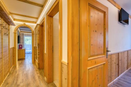 a hallway with wood paneling and a door at Appartement Hofmann in Königsleiten