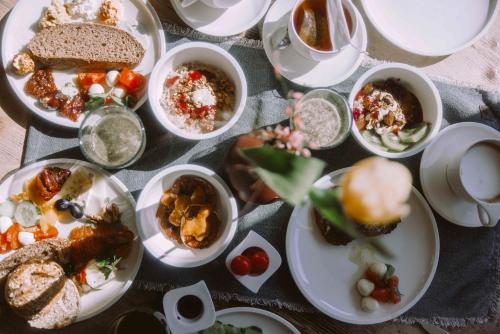 a table full of plates of food on a table at Stadthotel Brunner in Schladming