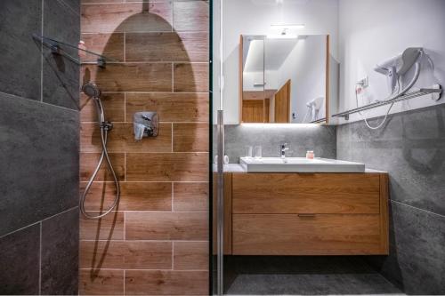 a bathroom with a sink and a shower at H55 in Balatonlelle