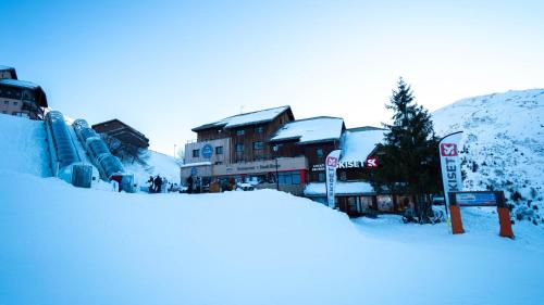 a pile of snow in front of some buildings at Hôtel Club "Les Carrettes" in Valmeinier