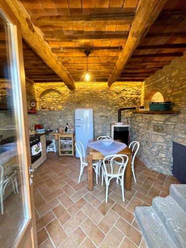 a kitchen with a table and chairs and a refrigerator at Affittacamere Il Vecchio Mandorlo in Quarrata